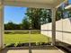 View from screened in porch, overlooking a manicured green lawn and privacy fence at 703 Hilchot Dr, Summerville, SC 29486