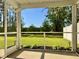 View from screened in porch, overlooking a manicured green lawn and trees at 703 Hilchot Dr, Summerville, SC 29486