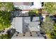 Aerial view of a home with a well-maintained roof, surrounded by green trees and a bricked driveway at 76 Radcliffe St, Charleston, SC 29403