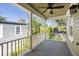 Spacious covered balcony with a ceiling fan, offering a view of the surrounding trees at 76 Radcliffe St, Charleston, SC 29403