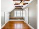 Attic bedroom featuring beautiful beams, a window seat, and wood floors at 76 Radcliffe St, Charleston, SC 29403