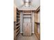 Spacious walk-in closet featuring custom wood shelving and cabinets for ample storage at 76 Radcliffe St, Charleston, SC 29403
