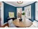 Dining room with blue walls, chandelier, wood floors, and open doorway to staircase at 76 Radcliffe St, Charleston, SC 29403