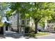 Beautiful two-story home with manicured lawn, mature trees, and brick-lined driveway at 76 Radcliffe St, Charleston, SC 29403