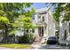 Charming two-story home with landscaped yard, porch, and black car in the driveway at 76 Radcliffe St, Charleston, SC 29403