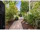 Charming walkway lined with lush greenery leading to the front entrance at 76 Radcliffe St, Charleston, SC 29403