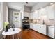 Well-lit kitchen with stainless steel appliances, granite countertops, and wooden floor at 76 Radcliffe St, Charleston, SC 29403