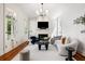 Bright living room features a fireplace, elegant chandelier, and modern furnishings at 76 Radcliffe St, Charleston, SC 29403