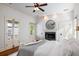 Bright bedroom with a fireplace, access to a balcony, and a comfortable bed setting at 76 Radcliffe St, Charleston, SC 29403