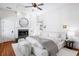 Serene bedroom with fireplace, a ceiling fan, and a luxurious bed with soft linens at 76 Radcliffe St, Charleston, SC 29403