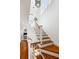 Elegant staircase with hardwood steps and white railings, leading to the upper level at 76 Radcliffe St, Charleston, SC 29403