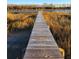 Picturesque wooden dock leading to a gazebo on the water, surrounded by tall marsh grasses at 7997 Doar Rd # C-3, Awendaw, SC 29429