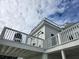 Exterior view features a white house, with white railings, and a partially cloudy blue sky in the background at 7997 Doar Rd # C-3, Awendaw, SC 29429