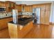 Well-equipped kitchen with wooden cabinets, granite countertops, and stainless steel appliances at 7997 Doar Rd # C-3, Awendaw, SC 29429