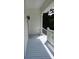 Side porch features include an outdoor light fixture, stairs with white railings, and a grey wood porch floor at 7997 Doar Rd # C-3, Awendaw, SC 29429