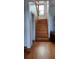 Classic wooden staircase featuring a side wood panel accent and natural light at 7997 Doar Rd # C-3, Awendaw, SC 29429