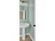 Stylish powder room features a pedestal sink, modern lighting, and refreshing mint walls at 819 Casey St, Moncks Corner, SC 29461