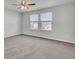 This is an empty bedroom with two windows, carpeted floors and a ceiling fan at 819 Casey St, Moncks Corner, SC 29461