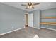 An empty bedroom features a ceiling fan, a window and floating shelves at 819 Casey St, Moncks Corner, SC 29461