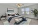 This bedroom features a ceiling fan, two windows and a blue rug beneath the bed at 819 Casey St, Moncks Corner, SC 29461