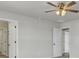 A vacant bedroom includes a ceiling fan, a doorway and carpeted floors at 819 Casey St, Moncks Corner, SC 29461