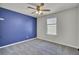Spacious bedroom features a modern ceiling fan, plush carpet and a vibrant accent wall at 819 Casey St, Moncks Corner, SC 29461