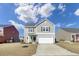 Charming two-story home featuring a well-manicured lawn and attached two car garage at 819 Casey St, Moncks Corner, SC 29461