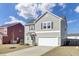 Charming two-story home with attached garage and tidy landscaping, showcasing a welcoming facade at 819 Casey St, Moncks Corner, SC 29461