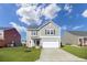 Charming two-story home boasts a well-manicured lawn and attached two-car garage at 819 Casey St, Moncks Corner, SC 29461