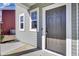 Inviting front entrance with secure brown door, sidelight windows, and neutral gray siding at 819 Casey St, Moncks Corner, SC 29461