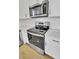 Close-up of modern kitchen with stainless steel appliances and white cabinetry at 819 Casey St, Moncks Corner, SC 29461