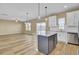 Bright open-concept kitchen flows into the spacious living room with sliding door access at 819 Casey St, Moncks Corner, SC 29461