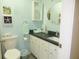Classic bathroom design with white cabinets and a seashell themed decor at 855 Club Cottage Rd, Edisto Island, SC 29438