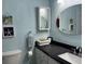 Well-lit bathroom featuring a decorative framed mirror, vanity, and modern fixtures at 855 Club Cottage Rd, Edisto Island, SC 29438