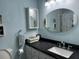 Well-lit bathroom featuring a decorative framed mirror, vanity, and modern fixtures at 855 Club Cottage Rd, Edisto Island, SC 29438