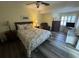 Cozy bedroom with a queen-sized bed, wood-look flooring, and plenty of natural light at 855 Club Cottage Rd, Edisto Island, SC 29438