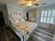 Comfortable bedroom with nautical themed bedding and wood laminate flooring at 855 Club Cottage Rd, Edisto Island, SC 29438