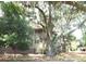 Beautiful home exterior surrounded by mature trees and a well-manicured landscape at 855 Club Cottage Rd, Edisto Island, SC 29438