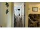 Open hallway view leading to the living area and bedroom with matching flooring at 855 Club Cottage Rd, Edisto Island, SC 29438