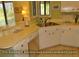 Bright kitchen with a corner sink, tile flooring, and plenty of countertop space at 855 Club Cottage Rd, Edisto Island, SC 29438