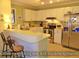 Bright kitchen open to living area with stainless steel appliances and ample countertop space at 855 Club Cottage Rd, Edisto Island, SC 29438