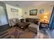 Comfortable living room featuring a cozy couch, wood laminate flooring, and stylish decor at 855 Club Cottage Rd, Edisto Island, SC 29438