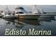 View of Edisto Marina showing boats and their reflections on the water at 855 Club Cottage Rd, Edisto Island, SC 29438