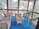Inviting screened porch area with comfortable seating and views of surrounding greenery at 855 Club Cottage Rd, Edisto Island, SC 29438