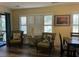 Comfortable wicker chairs and shuttered windows to let light in at 855 Club Cottage Rd, Edisto Island, SC 29438