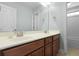 Bathroom featuring double sinks with a wood cabinet and large mirror at 8566 Royal Palm Ln, North Charleston, SC 29420
