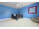 Cozy bedroom with blue walls, ceiling fan, and comfy beanbag chair at 8566 Royal Palm Ln, North Charleston, SC 29420