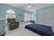 Inviting bedroom with a cozy chair, ceiling fan, and windows for natural light at 8566 Royal Palm Ln, North Charleston, SC 29420