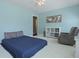 Comfortable bedroom with a ceiling fan, white walls, and a cozy rocking chair at 8566 Royal Palm Ln, North Charleston, SC 29420