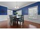 Charming dining area with hardwood floors, modern lighting, and large windows offer a warm ambiance at 8566 Royal Palm Ln, North Charleston, SC 29420